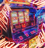 A vibrant scene featuring a classic slot machine with bright neon lights surrounding it. The slot machine displays symbols like 'Bar' and '7' and is set in a lively arcade environment. Reflections and colorful lighting add a sense of excitement and motion.