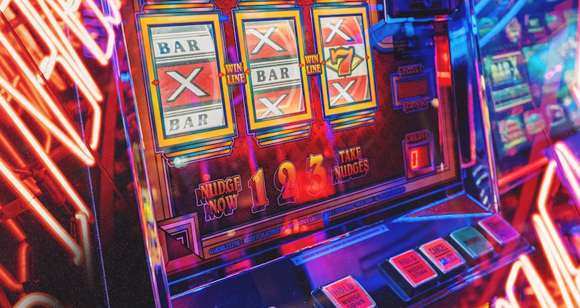 A vibrant scene featuring a classic slot machine with bright neon lights surrounding it. The slot machine displays symbols like 'Bar' and '7' and is set in a lively arcade environment. Reflections and colorful lighting add a sense of excitement and motion.
