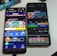 Two smartphones are displayed on a white surface, both showing gambling websites with colorful graphics, text, and various options for logging in and accessing games. The screens are bright and filled with promotional content related to casino and slot games.